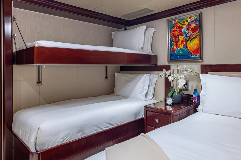 Slide: The Image of Luxurious 2007 Christensen Tri-Deck yacht cabin with bunk beds, vibrant artwork, and elegant decor. - 30
