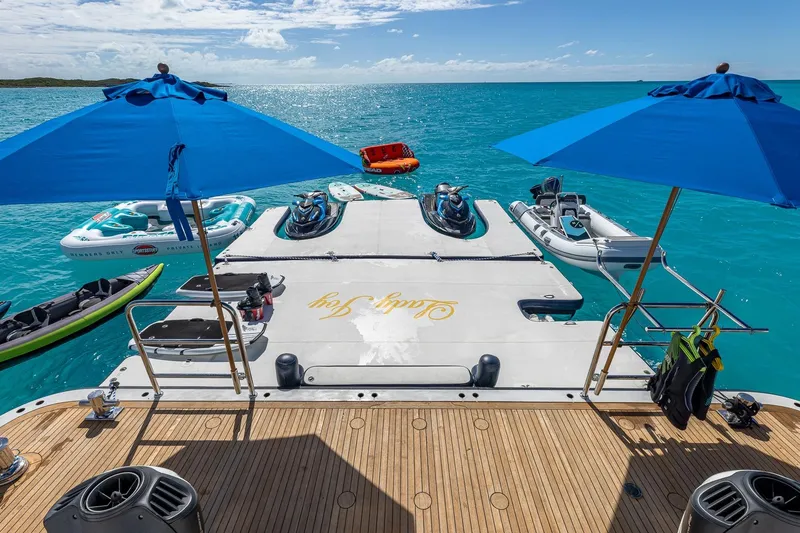 Slide: The Image of Luxurious 2007 Christensen Tri-Deck yacht deck with water sports equipment and blue umbrellas. - 53