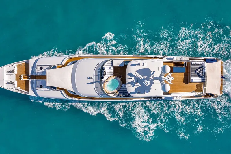 Slide: The Image of Aerial view of 2007 Christensen Tri-Deck yacht cruising in turquoise waters. - 58