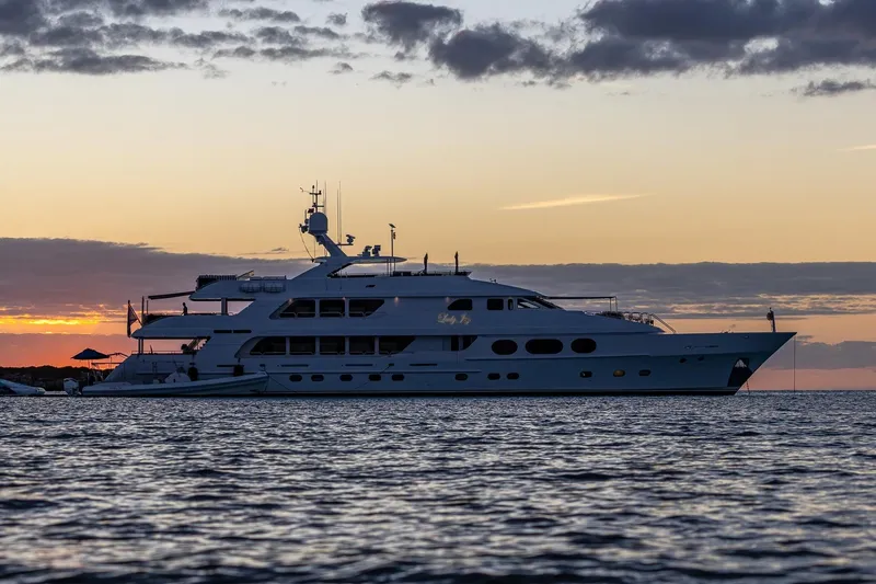 Slide: The Image of Luxurious 2007 Christensen Tri-Deck yacht at sunset on calm waters. - 59