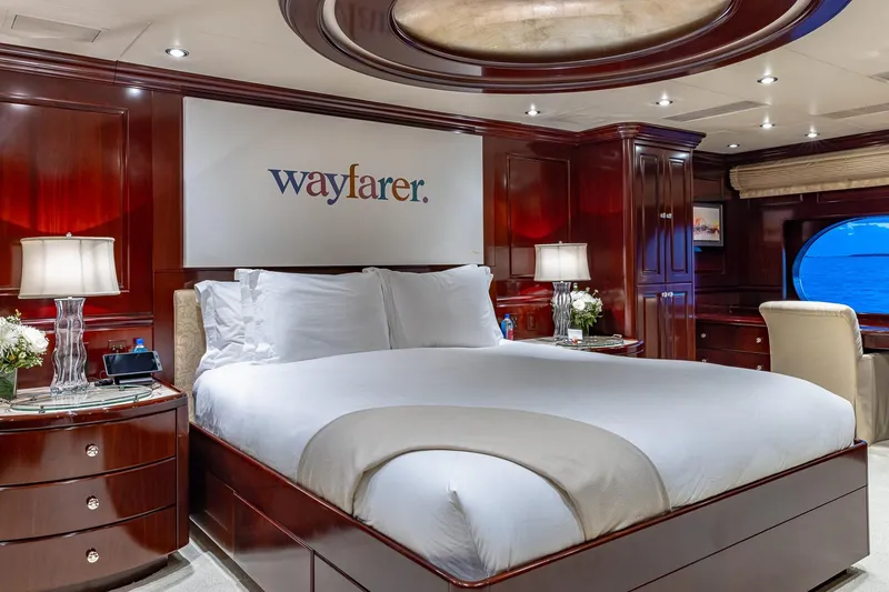 Slide: The Image of Luxurious bedroom on 2007 Christensen Tri-Deck yacht with elegant wood paneling and ocean view. - 9