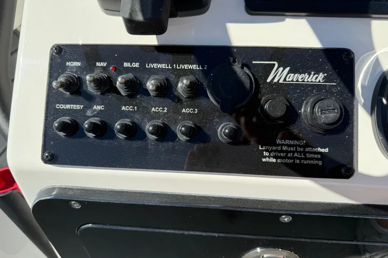 Slide: The Image of Control panel of 2026 Maverick 17 HPX-S boat with various switches and warning label. - 14