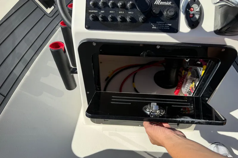 Slide: The Image of 2026 Maverick 17 HPX-S boat console with open storage compartment and control panel. - 16