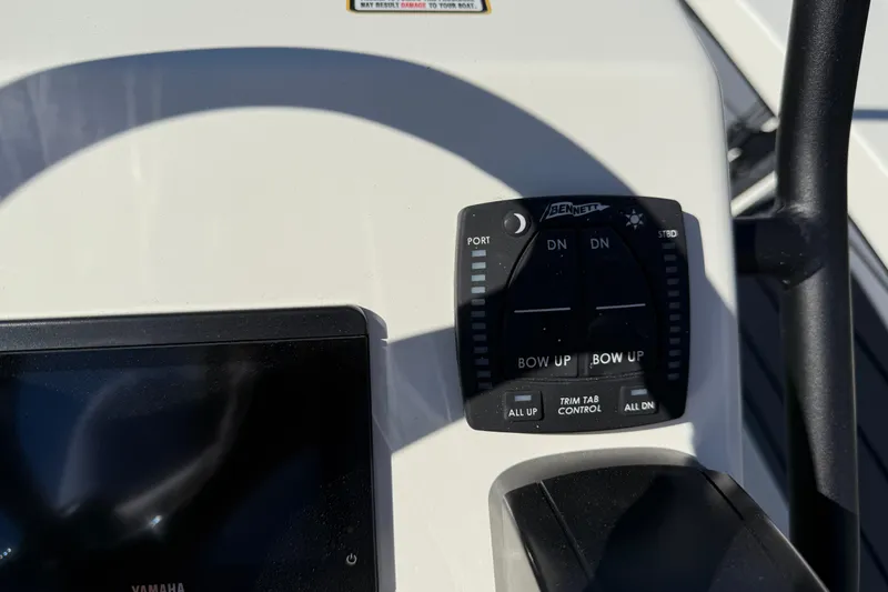 Slide: The Image of Control panel of 2026 Maverick 17 HPX-S boat with trim tab controls. - 17