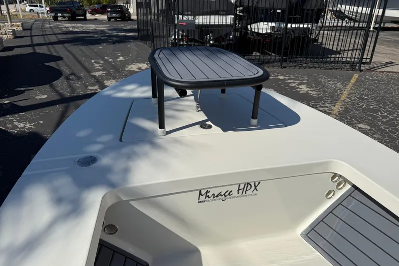 Slide: The Image of 2026 Maverick 17 HPX-S boat with elevated platform, parked outdoors. - 24