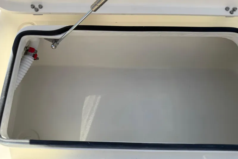 Slide: The Image of Open storage compartment of 2026 Maverick 17 HPX-S boat, featuring hydraulic support. - 27