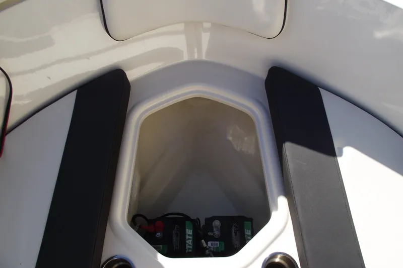 Slide: The Image of 2022 Bayliner VR4 Bowrider OB storage compartment with battery visible. - 11