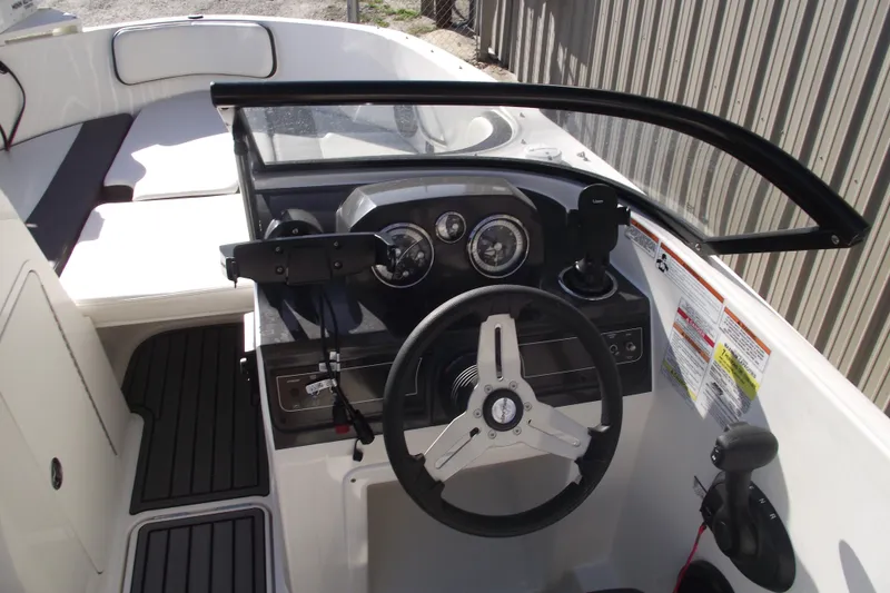 Slide: The Image of 2022 Bayliner VR4 Bowrider OB cockpit with steering wheel and dashboard controls. - 15