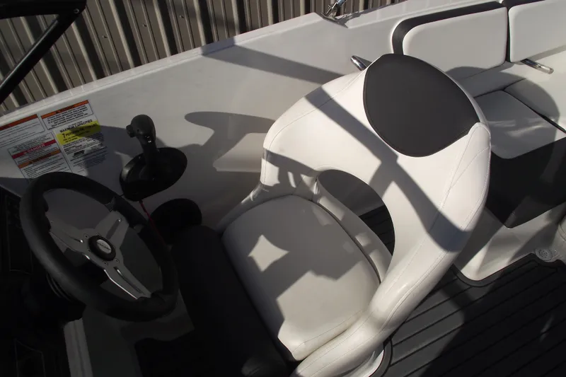Slide: The Image of 2022 Bayliner VR4 Bowrider OB cockpit with steering wheel and white seating. - 18