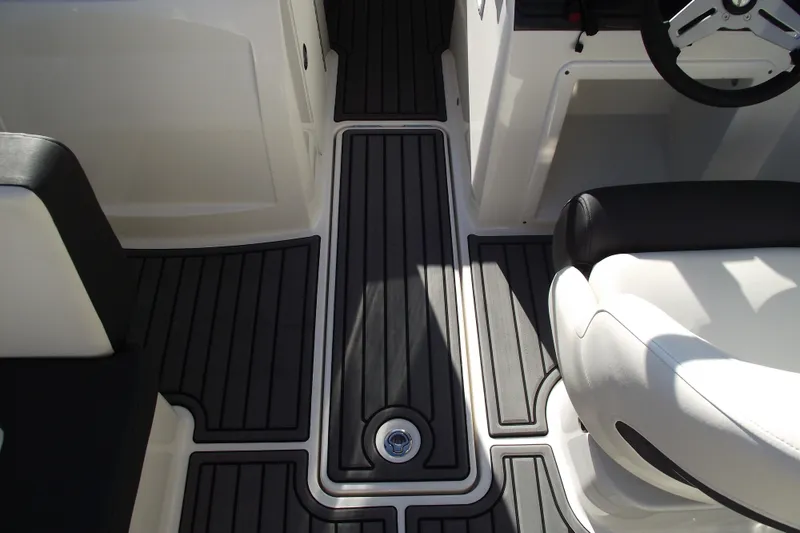Slide: The Image of 2022 Bayliner VR4 Bowrider OB interior with sleek black and white seating. - 19