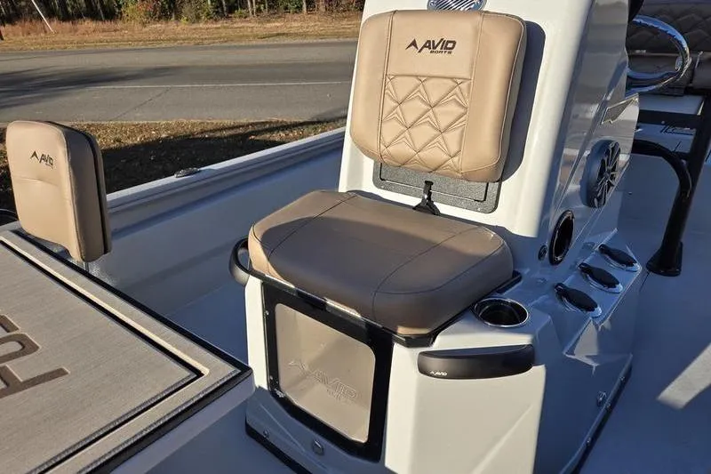 Slide: The Image of Avid 21 Fusion 2026 boat interior with beige seating and console details. - 14