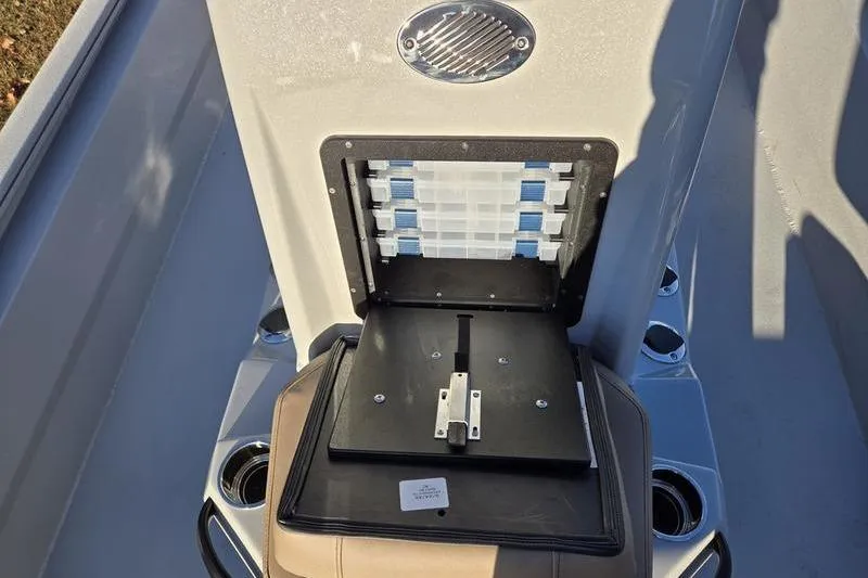 Slide: The Image of Avid 21 Fusion 2026 boat storage compartment with tackle boxes and cup holders. - 15