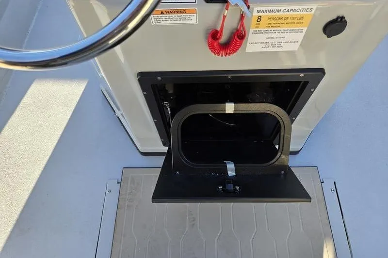 Slide: The Image of 2026 Avid 21 Fusion boat console with storage compartment and safety warnings. - 17