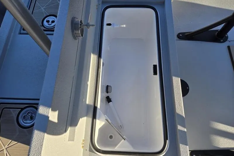 Slide: The Image of Open storage compartment on 2026 Avid 21 Fusion boat deck. - 18