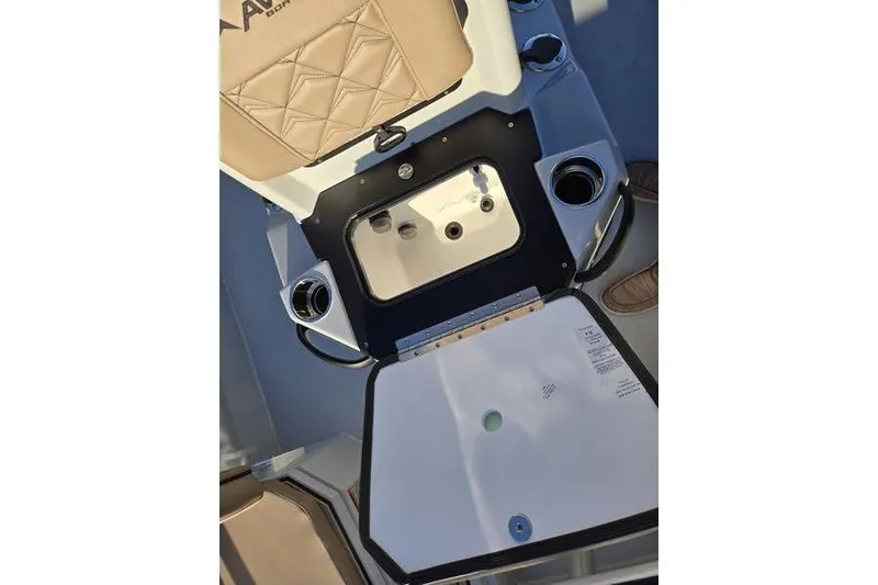 Slide: The Image of Avid 21 Fusion 2026 boat interior with storage compartment and cup holders. - 19
