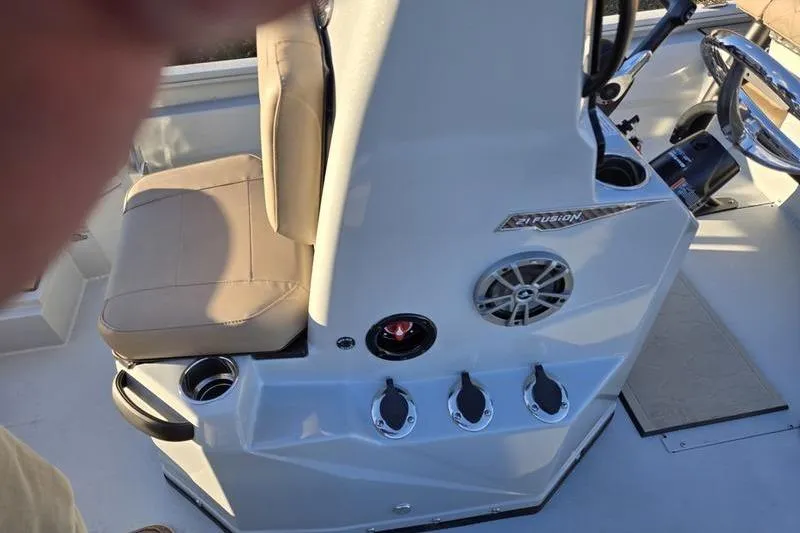 Slide: The Image of Interior of 2026 Avid 21 Fusion boat with beige seating and control panel. - 20