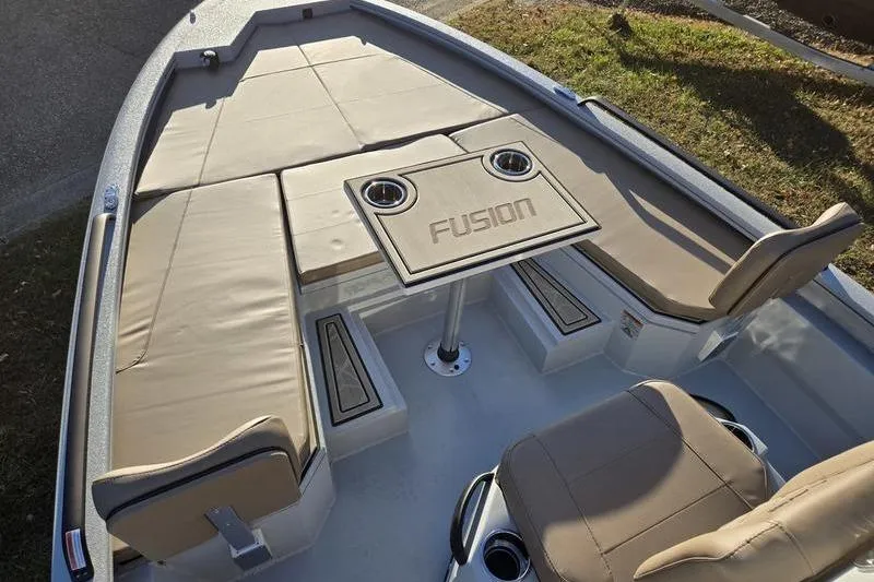 Slide: The Image of 2026 Avid 21 Fusion boat interior with cushioned seating and table. - 21