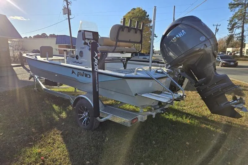 Slide: The Image of Avid 21 Fusion 2026 boat on trailer with Yamaha outboard motor, parked outdoors. - 4