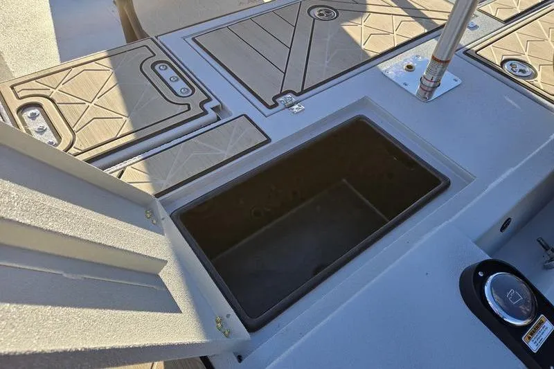 Slide: The Image of Avid 21 Fusion 2026 boat deck with open storage compartment and textured flooring. - 5
