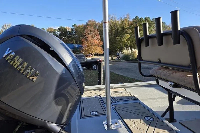 Slide: The Image of Avid 21 Fusion 2026 boat with Yamaha engine, rod holders, and seating, outdoors. - 9