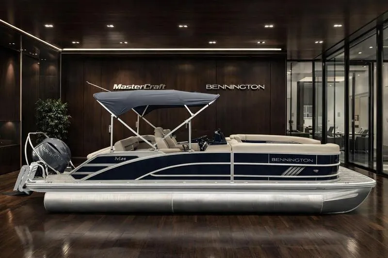 The Image of 2026 Bennington M Swingback 24 MSB pontoon boat displayed in a showroom. - 0