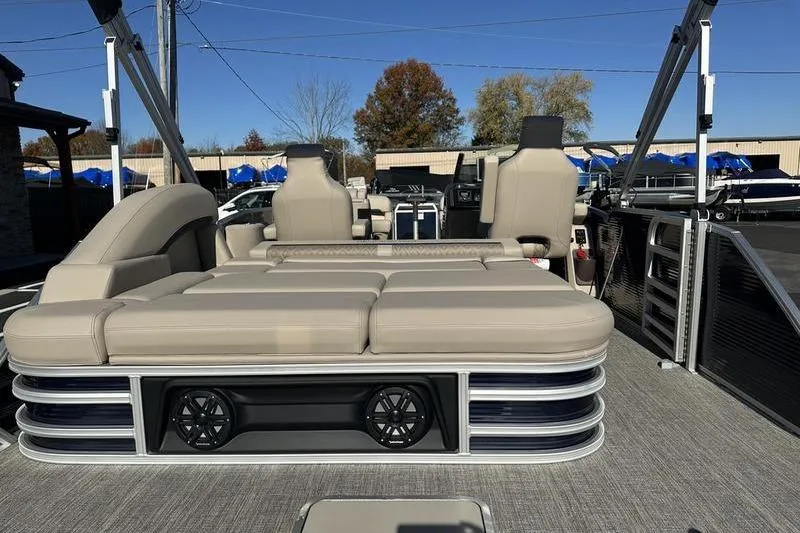 Slide: The Image of 2026 Bennington M Swingback 24 MSB pontoon boat at dealership, side view. - 2