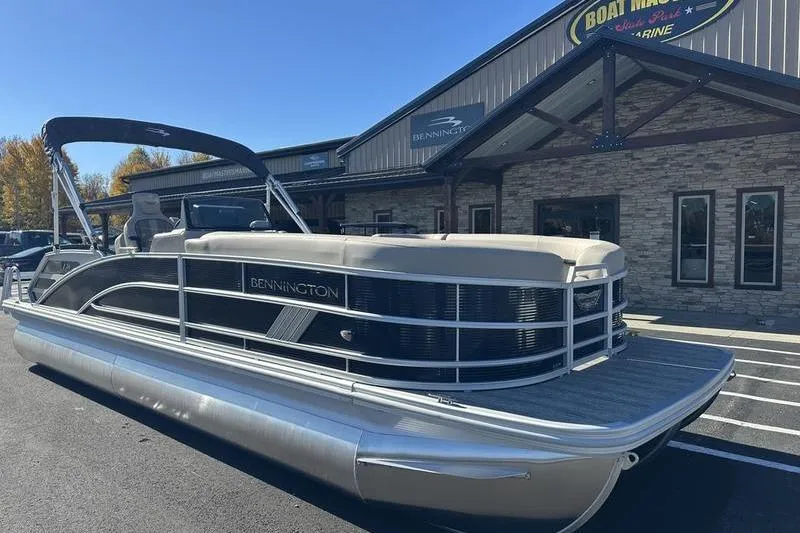 Slide: The Image of 2026 Bennington M Swingback 24 MSB pontoon boat parked outside dealership. - 3