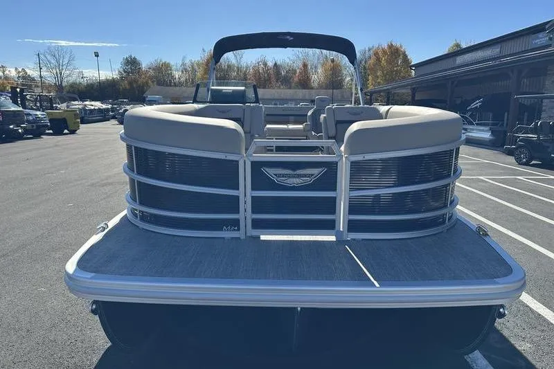 Slide: The Image of 2026 Bennington M Swingback 24 MSB pontoon boat with canopy in parking lot. - 4
