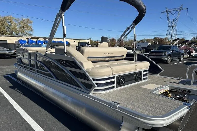 Slide: The Image of 2026 Bennington M Swingback 24 MSB pontoon boat with Yamaha outboard motor, docked outdoors. - 8