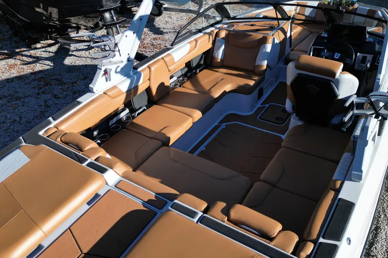 Slide: The Image of 2021 Malibu M220 boat interior with luxurious tan seating and modern design. - 10