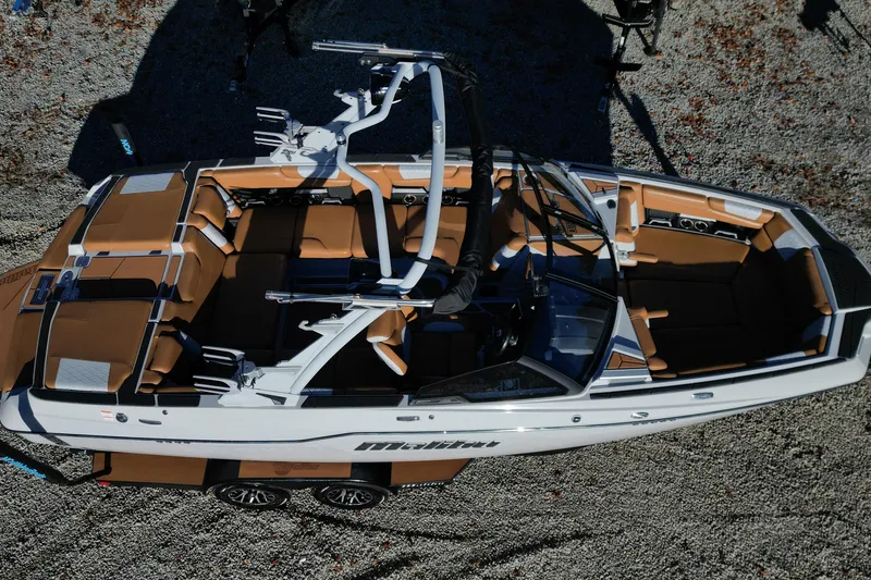 Slide: The Image of Aerial view of 2021 Malibu M220 boat with tan interior and sleek design. - 5