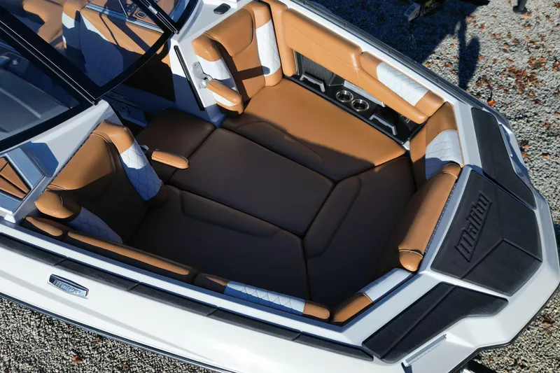 Slide: The Image of 2021 Malibu M220 boat interior with brown and white seating, overhead view. - 7