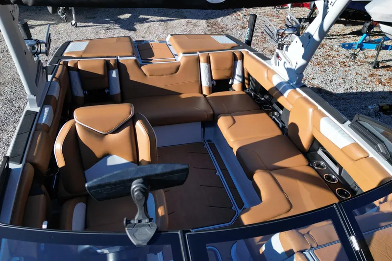 Slide: The Image of 2021 Malibu M220 boat interior with tan leather seating and modern design. - 8