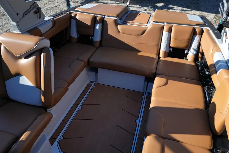 Slide: The Image of Luxurious interior of 2021 Malibu M220 boat with brown leather seating. - 9