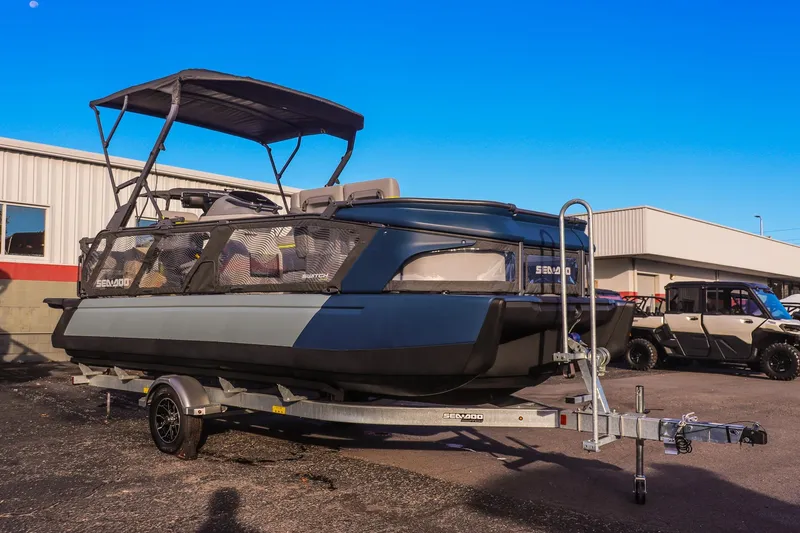 The Image of 2025 Sea-Doo Switch Cruise Limited 21 pontoon boat on trailer, parked outdoors. - 0