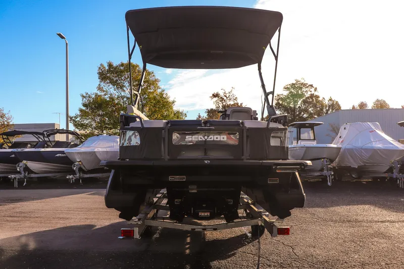 Slide: The Image of 2025 Sea-Doo Switch Cruise Limited 21 boat on trailer, rear view in a marina. - 3