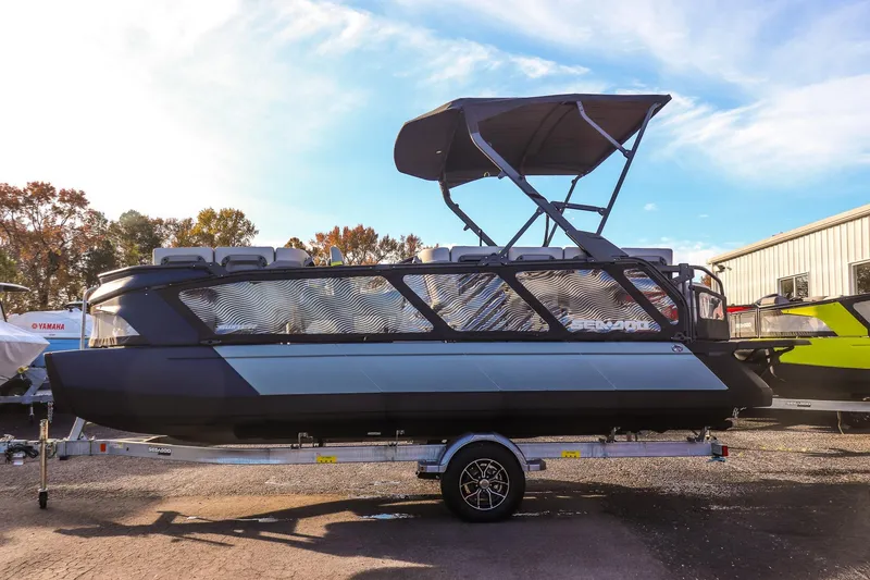 Slide: The Image of 2025 Sea-Doo Switch Cruise Limited 21 pontoon boat on trailer, outdoor setting. - 4