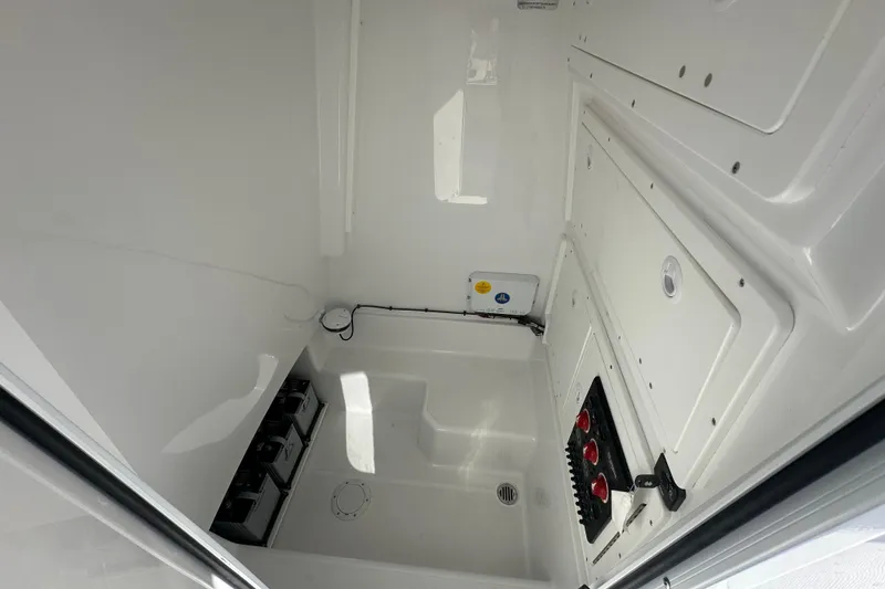 Slide: The Image of 2026 Bluewater 25t boat interior with control panel and storage compartments. - 14