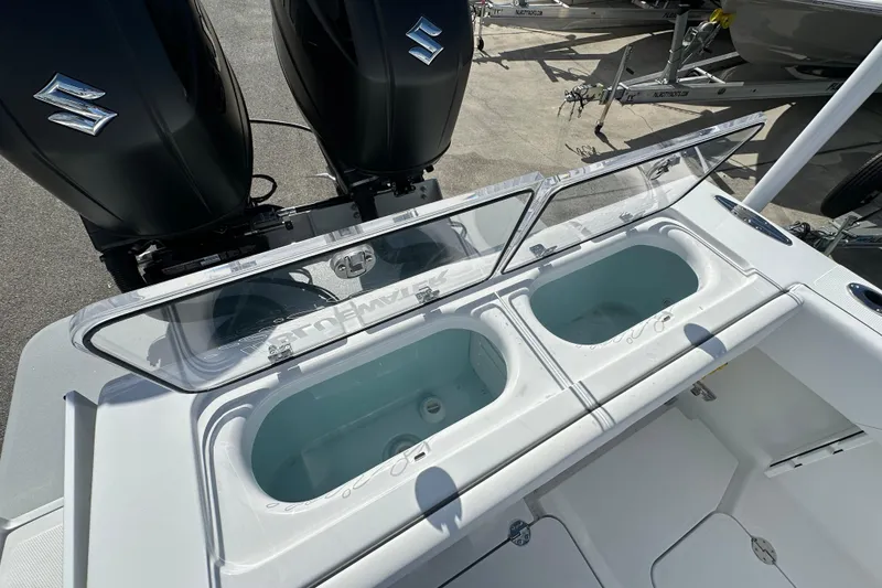 Slide: The Image of 2026 Bluewater 25t boat with dual Suzuki engines and open livewell compartments. - 17