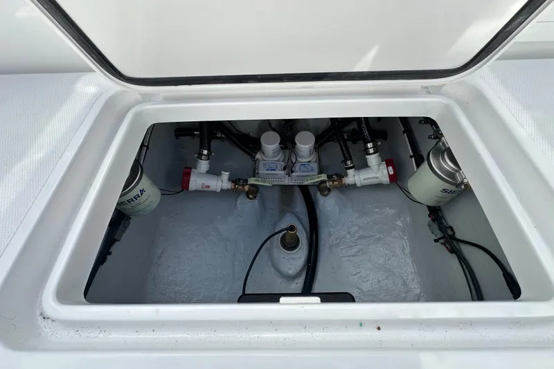 Slide: The Image of Engine compartment of 2026 Bluewater 25t boat, featuring fuel filters and plumbing components. - 22