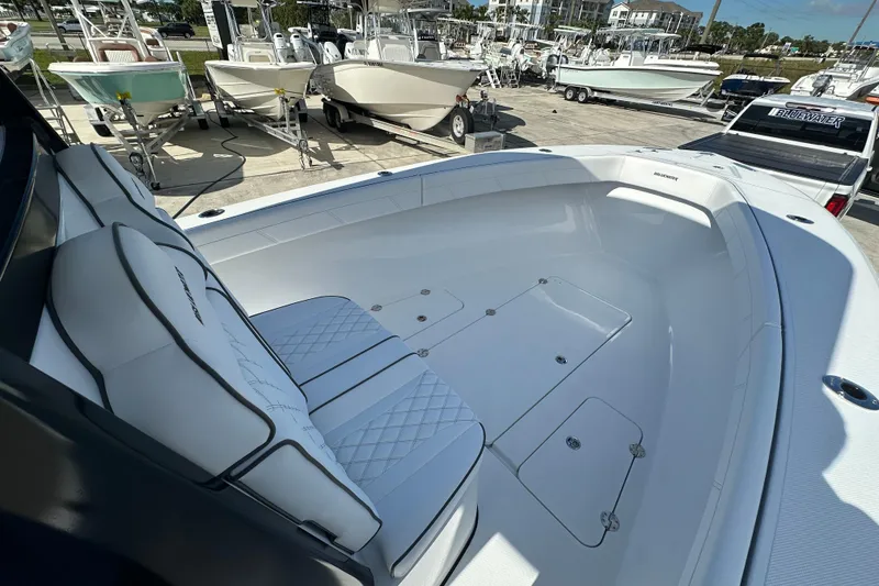 Slide: The Image of 2026 Bluewater 25t boat interior with cushioned seating and storage compartments. - 8