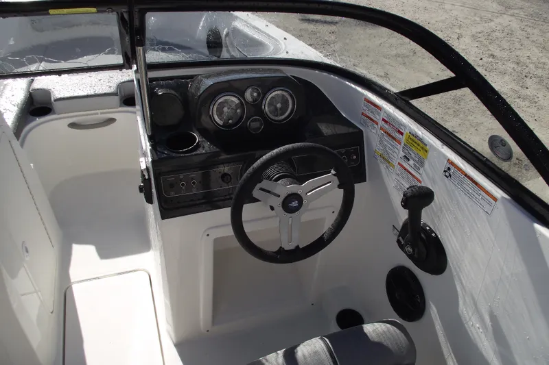 Slide: The Image of 2026 Bayliner VR4 Bowrider OB cockpit with steering wheel and control panel. - 13
