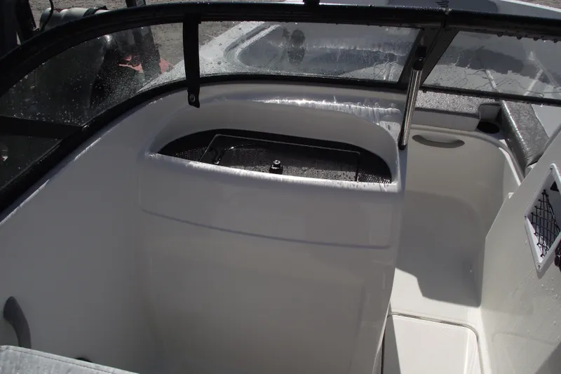 Slide: The Image of 2026 Bayliner VR4 Bowrider OB interior with sleek design and storage compartment. - 16