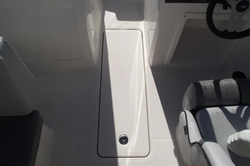 Slide: The Image of 2026 Bayliner VR4 Bowrider OB interior with seating and storage compartment. - 18