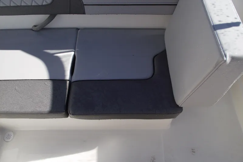 Slide: The Image of 2026 Bayliner VR4 Bowrider OB interior seating with gray cushions. - 22