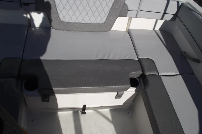 Slide: The Image of 2026 Bayliner VR4 Bowrider OB interior seating with gray upholstery and cup holders. - 25