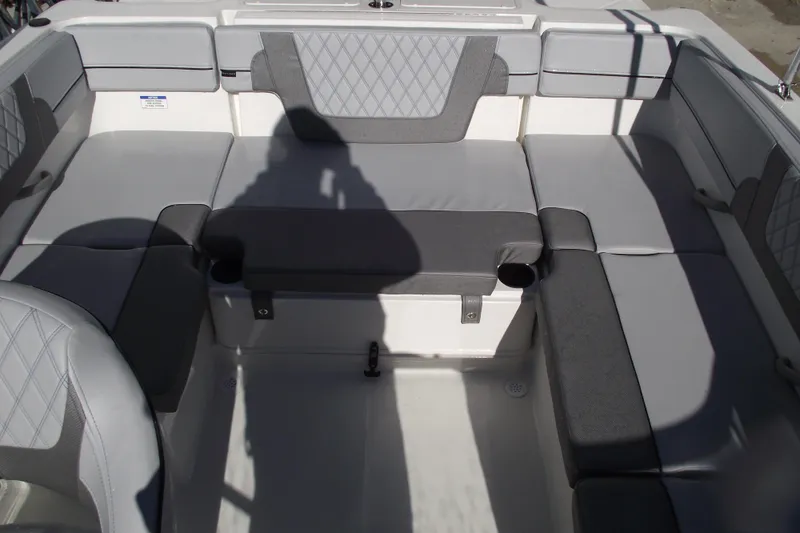 Slide: The Image of 2026 Bayliner VR4 Bowrider OB interior seating with gray upholstery and cup holders. - 35