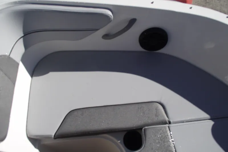 Slide: The Image of 2026 Bayliner VR4 Bowrider OB interior seating with cup holder and speaker. - 7