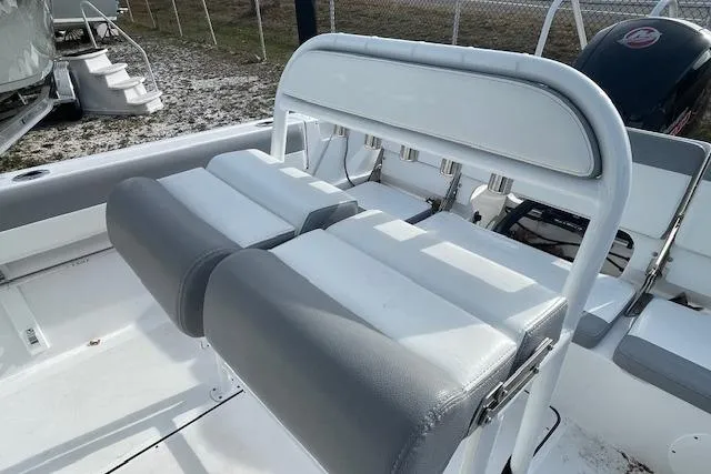 Slide: The Image of 2021 Release 210 RX boat interior with cushioned seating and rod holders. - 15