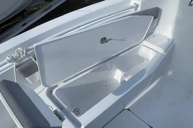 Slide: The Image of Open storage compartment on 2021 Release 210 RX boat deck. - 19